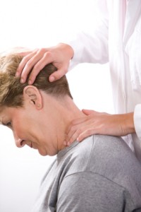 physical therapist examines the neck